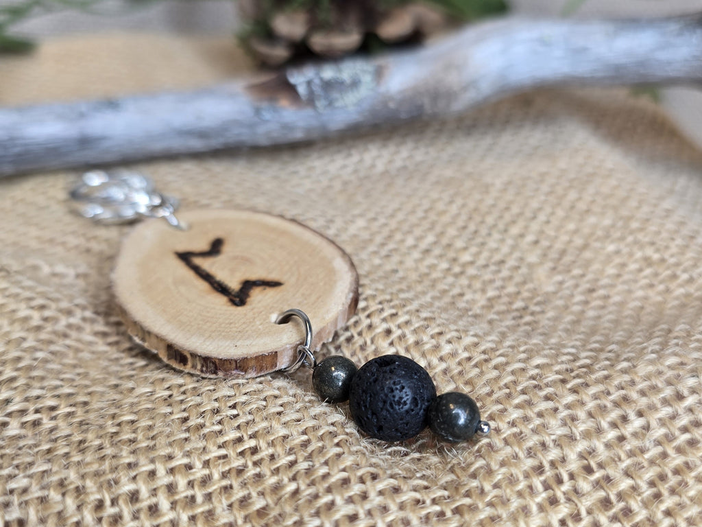 Avaimenperä, Puukiekko, jossa polttokuvioitu perth-riimu, pyriitti- ja laavakivihelmet. 