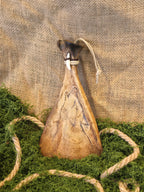 kauriin lapaluu koriste, jossa ketunhammas ja polttokuvioitu susi.