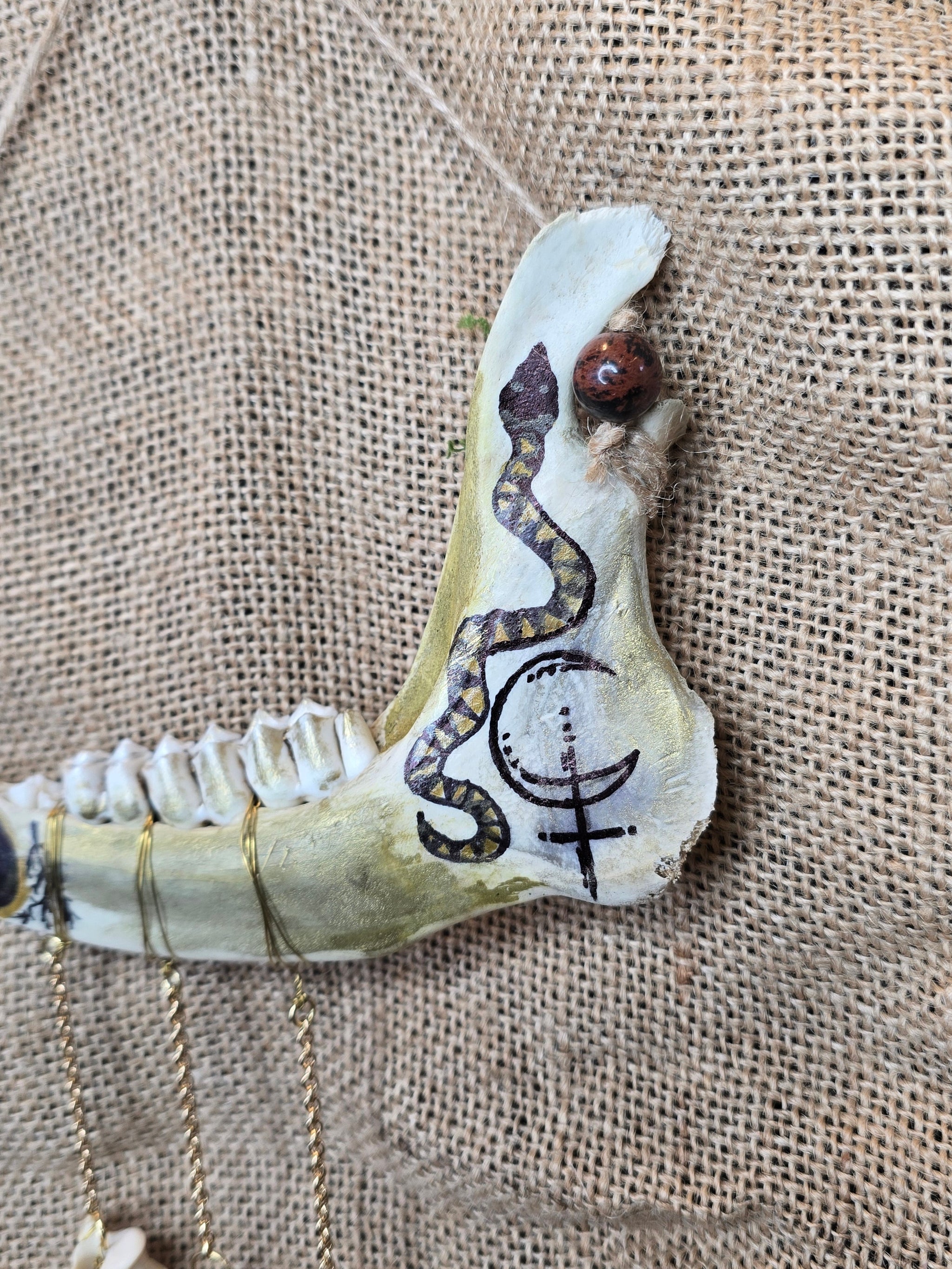 Kauriin leukaluu seinäkoriste, Lilith symbolilla. Lähikuva Lilith-symbolista. 