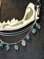 Ketunleukaluusta valmistettu kaulakoru, koristeltu sammalein ja sammalakaattihelmillä.Lähikuva yksityiskohdista.