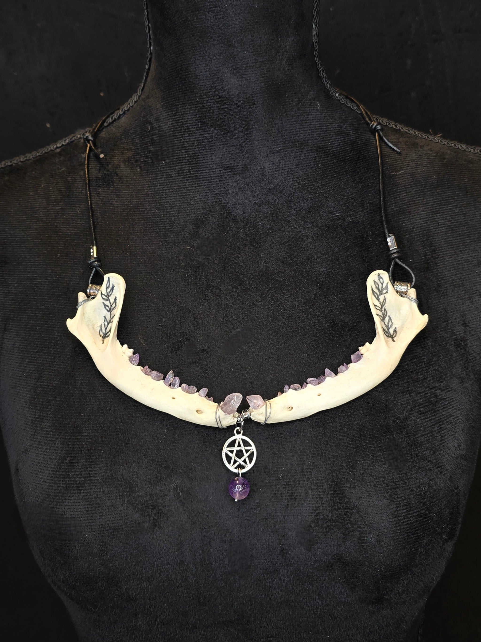 Ketun leukaluista, ametistisiruista tehty kaulakoru pentagram riipuksella.