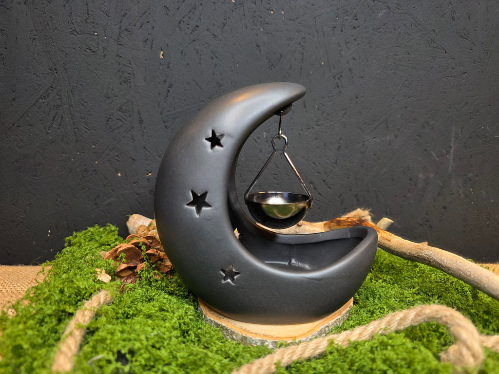 Kuunsirpin muotoinen musta tuoksulyhty. 