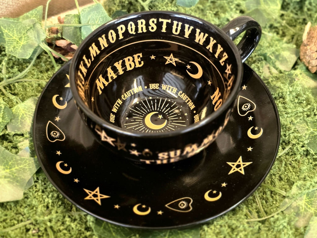 Teesetti ennustamiseen,musta kuppi, lautanen ja opaskirja 