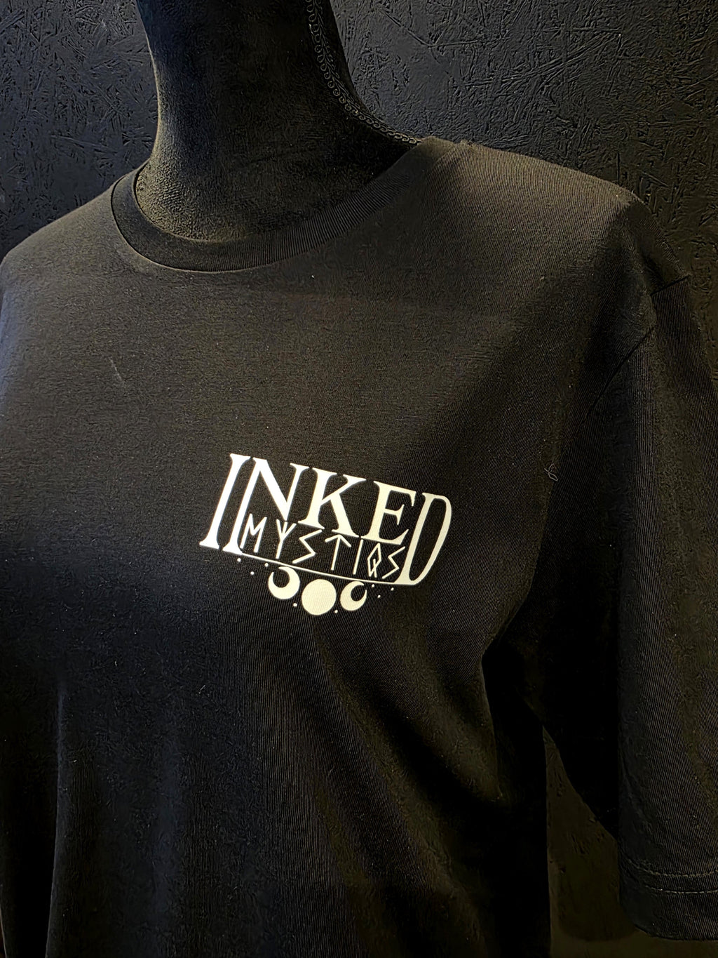 Inked Mystiqs Kurikan noitavainot 2025, musta t-paita, unisex malli. Painatus edessä ja tak