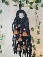 Musta Noitakello, jossa pentagram ja avain symboli, viisi ruosteenpunaista kelloa. 